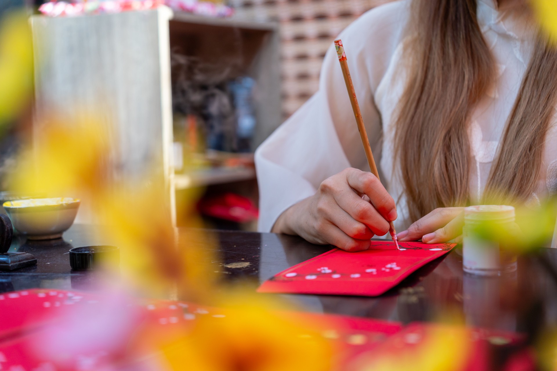 Selective focus of hand of Vietnamese scholar writes calligraphy at lunar new year. Calligraphy festival is a popular tradition during Tet holiday.